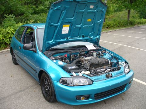 1991 Ford Probe - This teal 1991 Honda Civic hatchback has its hood open, revealing the engine bay.