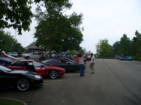 1991 Ford Probe - A red 1991 Ford Probe is parked in a lot with several other cars, some with hoods open.