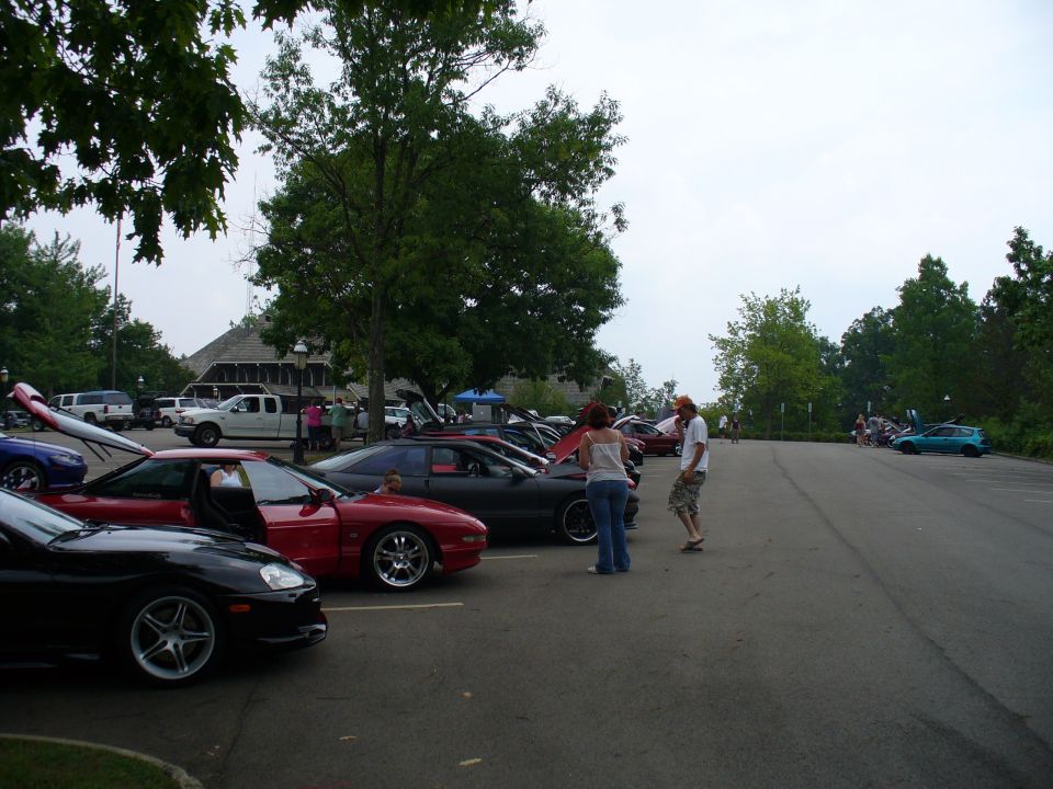 Red 1991 Ford Probe parked in a lot with hoods up