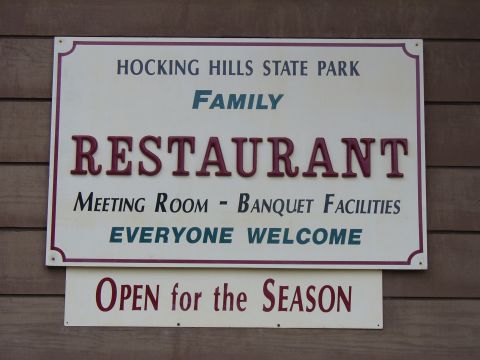 1991 Ford Probe - A sign for Hocking Hills State Park Family Restaurant indicates it is open for the season.