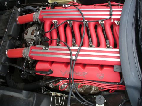 1991 Ford Probe - Engine bay view of a red V10 engine Viper badging and silver stripes on the intake manifold.