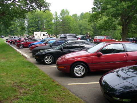 1991 Ford Probe - A line of Ford Probes are parked in a lot, with a red one prominently in the foreground.