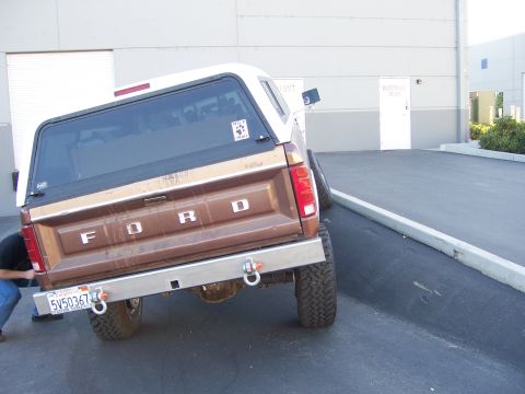 1991 Ford Bronco - Rear view of a 1991 Ford Bronco, modified with a custom bumper and off-road tires.