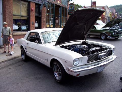 1972 Ford Ranchero - A white coupe with its hood open is parked on a street, with another car visible in the background.