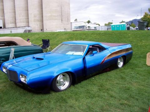 1972 Ford Ranchero - A custom 1972 Ford Ranchero with a two-tone paint job and chrome wheels is displayed outdoors.