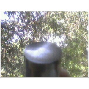 1972 Ford Ranchero - A close-up shot focuses on a dark, rounded object against a blurred background of trees, a SuperMotors logo.