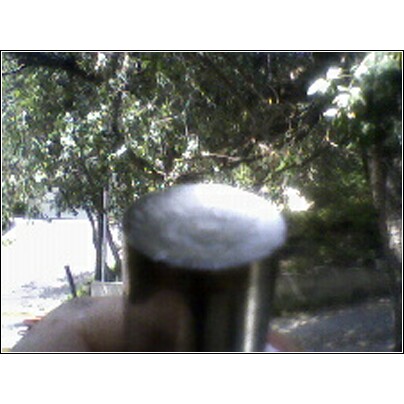 1972 Ford Ranchero - A metal cap is shown in close-up, with a hand holding the object it is attached to.