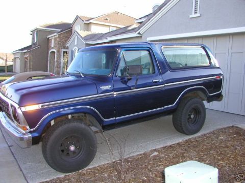 1978 Ford Bronco - Blue 1978 Ford Bronco parked in front of a suburban house and garage.