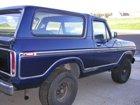 1978 Ford Bronco - The side profile of a blue Ford Bronco shows its distinctive body lines and chrome trim.