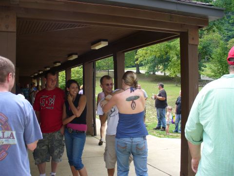 1991 Ford Probe - A group of people are socializing under a covered pavilion at an outdoor gathering.