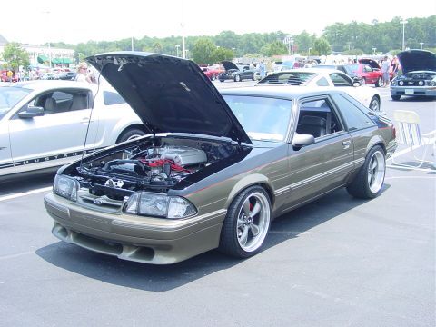 1986 Ford Mustang - A modified 1987 Ford Mustang is displayed with its hood up at an outdoor car event.