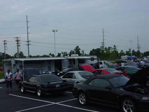 1986 Ford Mustang - A gathering of Ford Mustangs, with a trailer that appears to be a mobile service unit.