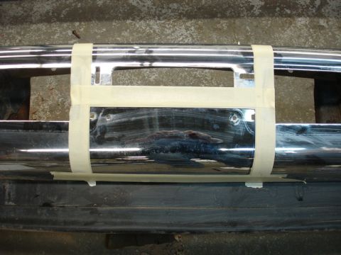 1996 Ford Bronco - Chrome bumper section with masking tape applied, likely for a winch installation project.