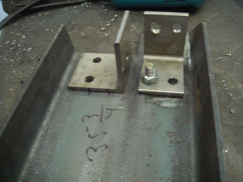 1996 Ford Bronco - Metal brackets and bolts are shown attached to a steel beam, with handwritten markings on the beam.
