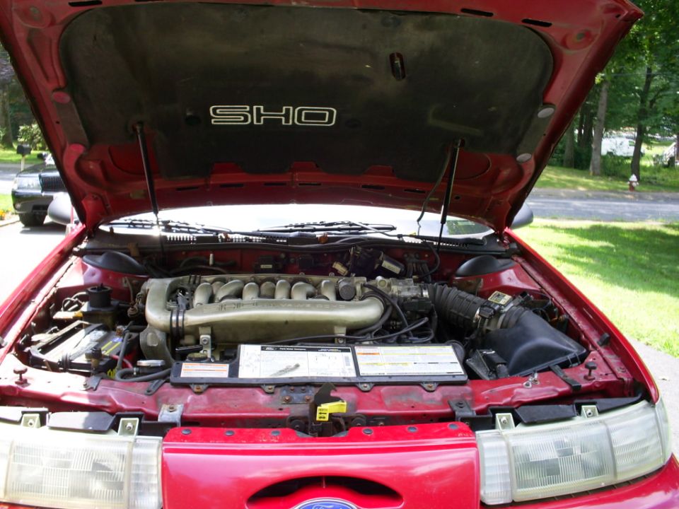 1995 Ford Taurus SHO engine bay with hood open. The V8 engine is visible