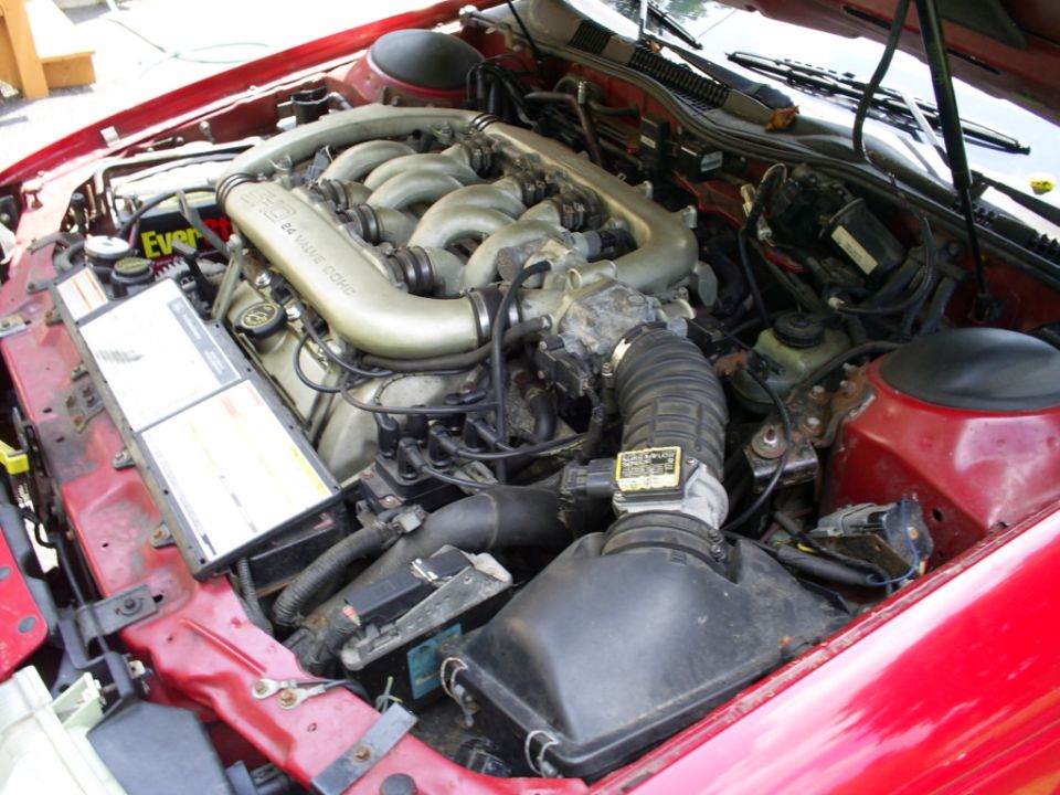 Red 1995 Ford Taurus engine bay with a V6 24 valve DOHC engine