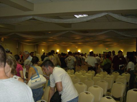 1986 Ford Bronco - A large group of people are congregated inside a decorated conference room.