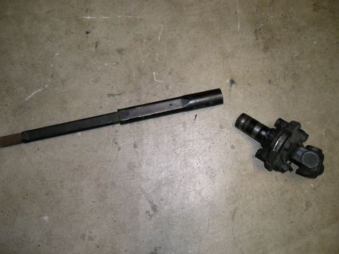 1986 Toyota Hilux - A disassembled steering shaft and its universal joint lie on a concrete surface.