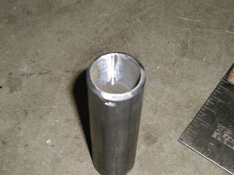 1986 Toyota Hilux - A metal tube and a ruler are shown on a concrete surface.