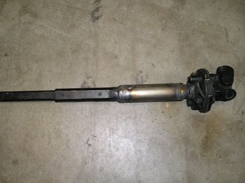 1986 Toyota Hilux - This is a steering shaft assembly, likely for a vehicle, shown on a concrete floor.