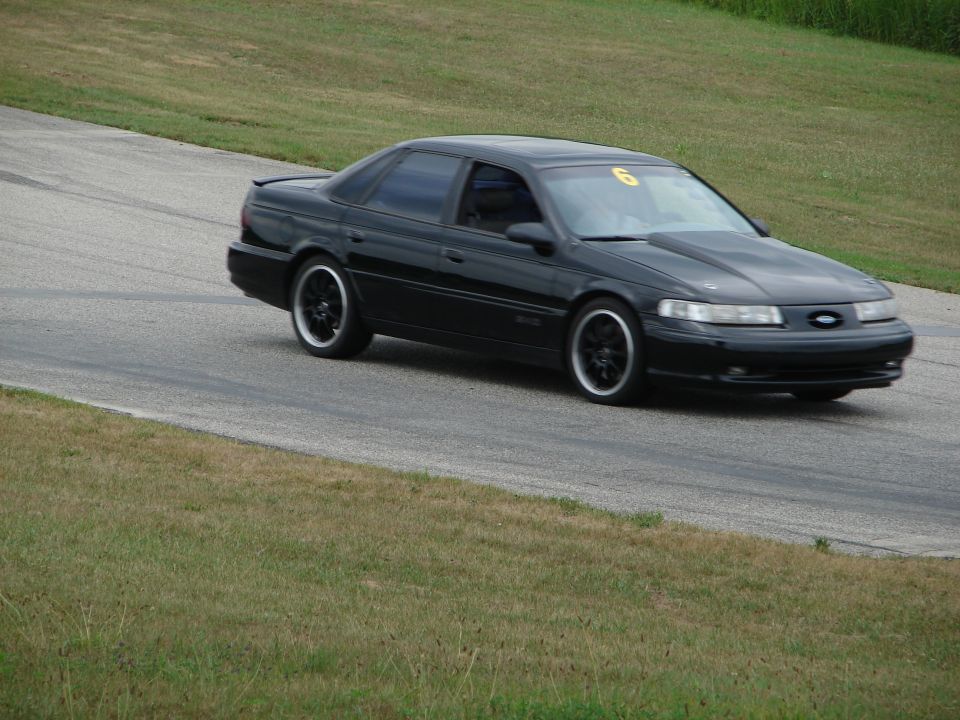 1993 Ford Taurus on a race track, number 6 on windshield
