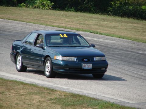 1993 Ford Taurus - A 1993 Ford Taurus with racing number 14 is seen on a road course.