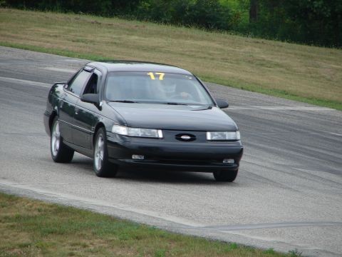 1993 Ford Taurus - A black 1993 Ford Taurus is seen on a race track, with the number 17 visible on its windshield.