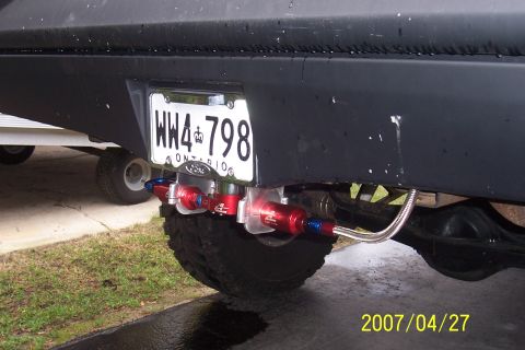 1977 Ford F-150 - Close-up of a truck's rear bumper showing an Ontario license plate and an aftermarket fuel filter system.