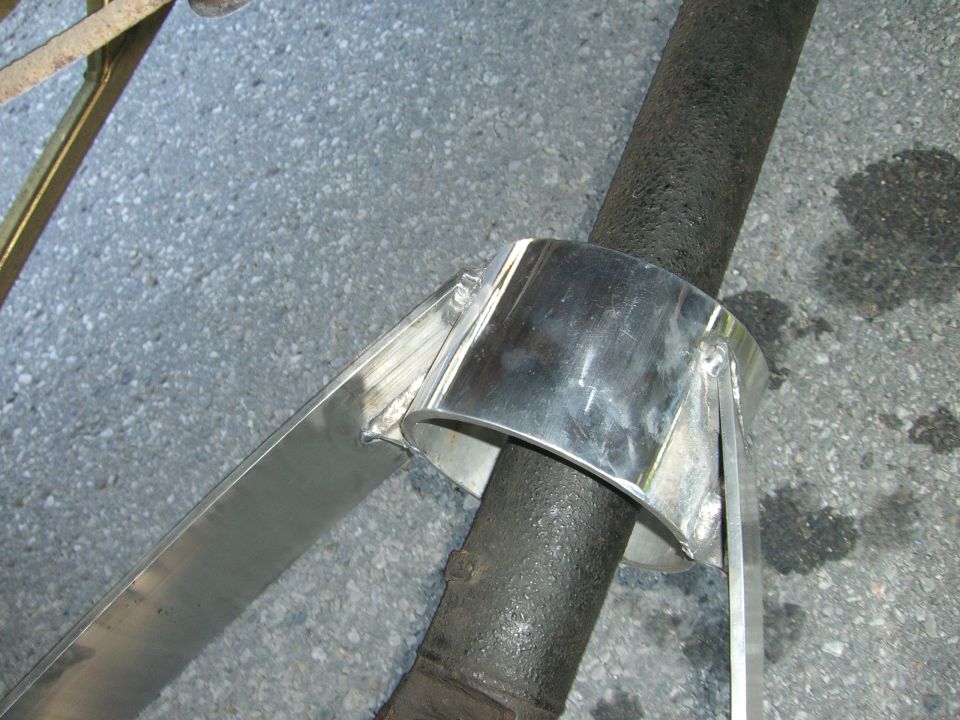 Custom polished metal exhaust pipe clamp on dark pipe