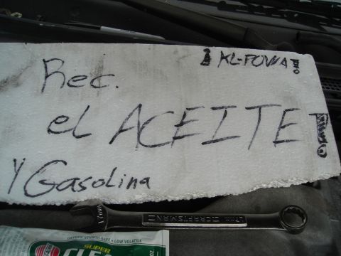 1995 Mazda MX-6 - Handwritten note in engine bay with tools, possibly indicating maintenance tasks.
