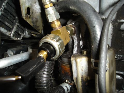 1995 Mazda MX-6 - This image shows a close-up view of an engine's oil pressure sensor and associated plumbing.