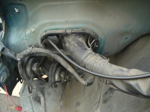 1995 Mazda MX-6 - Automotive wiring and hose assembly shown in the inner fender area of a vehicle.