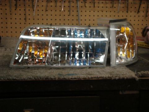 2000 Ford Crown Victoria - Pair of headlights for a 2000 Ford Crown Victoria, likely for restoration or repair.