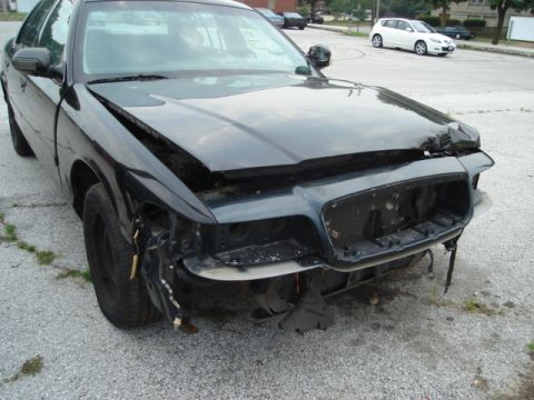 2000 Ford Crown Victoria - This 2000 Ford Crown Victoria shows significant damage to its front end, including a missing grille and bumper.