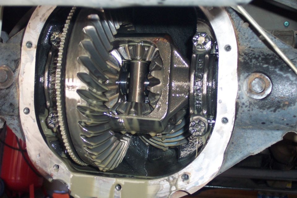 Open rear differential showing ring gear, carrier and spider gears with cover removed