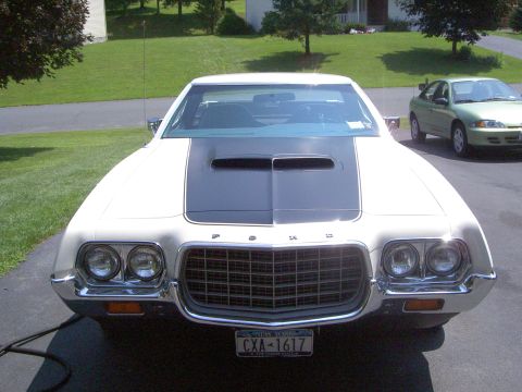 1972 Ford Ranchero - Front view of a white 1972 Ford Ranchero with a black hood stripe and a second green car in the background.