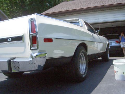 1972 Ford Ranchero - Low rear three-quarter view of a white Ford Ranchero in a driveway, highlighting the vertical taillight, chrome rear bumper with rubber bum…