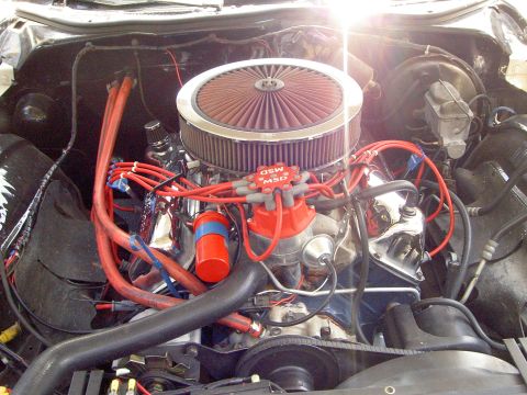 1972 Ford Ranchero - Overhead view into a V8 engine bay dominated by a large chrome-lidded open-element air cleaner with a red K&N-style filter, sitting above a…