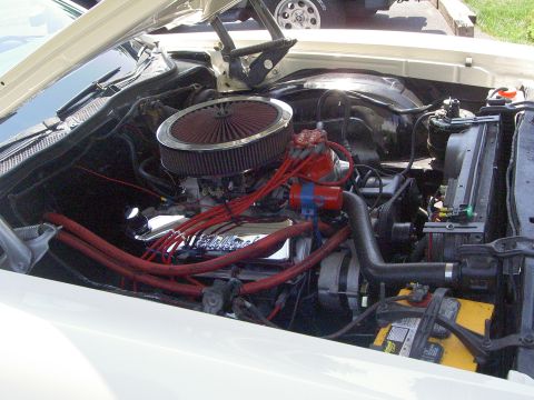 1972 Ford Ranchero - The engine bay of a 1972 Ford Ranchero shows off its chrome valve covers and bright red spark plug wires.