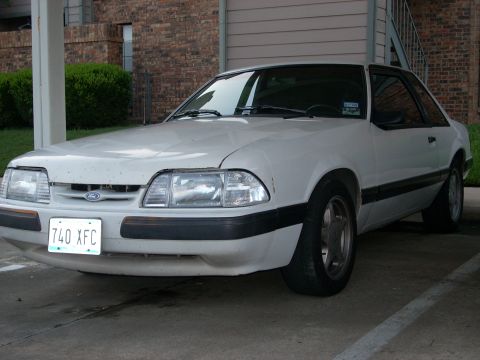 1991 Ford Mustang - Front view of a white 1991 Ford Mustang coupe parked outdoors.