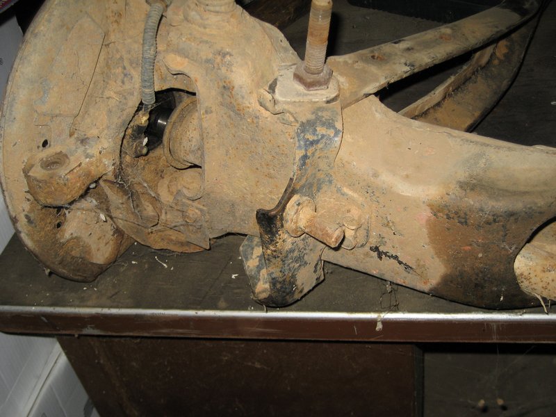 Rusty suspension part with a bolt and wiring