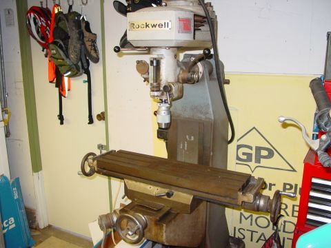 1994 Ford Bronco - A Rockwell milling machine is shown in a workshop setting with gear hanging on the wall.