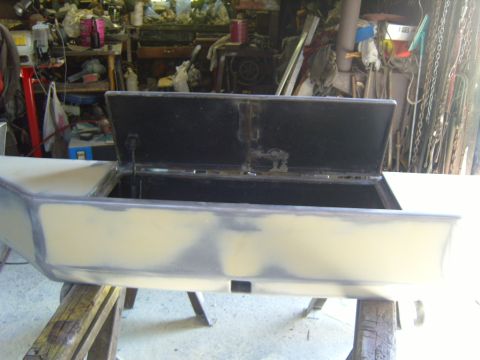 1989 Ford Bronco - Bumper undergoing bodywork and prep for repainting in a workshop.