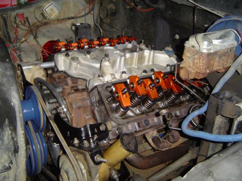 1978 Ford Bronco - Engine bay showing a close-up of the valve train with bright orange rocker arms.