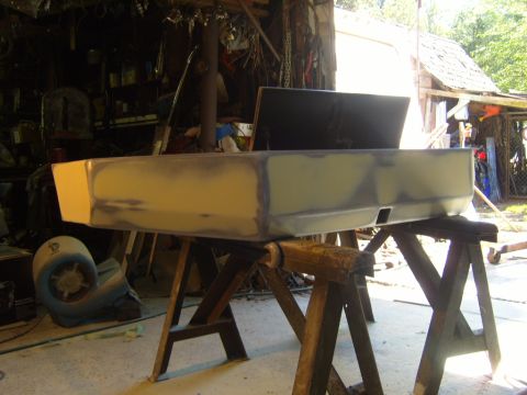 1989 Ford Bronco - Bumper is prepped for paint in a workshop setting.