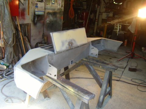 1989 Ford Bronco - A Ford Bronco front bumper is being prepped for bodywork and painting in a garage setting.