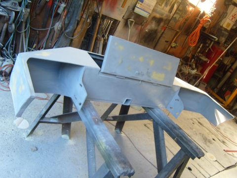 1989 Ford Bronco - Front bumper is prepped for paint, mounted on sawhorses in a workshop.
