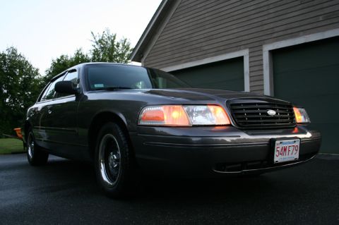 2000 Ford Crown Victoria - This 2000 Ford Crown Victoria is shown in a 3q-front view, its dark gray paint and license plate 54MF79.