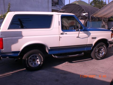 1991 Ford Bronco - This 1991 Ford Bronco is shown from the side, parked on a paved surface.