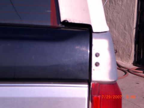 1991 Ford Bronco - Close-up of the rear corner of a vehicle, showing the taillight and body panel details.